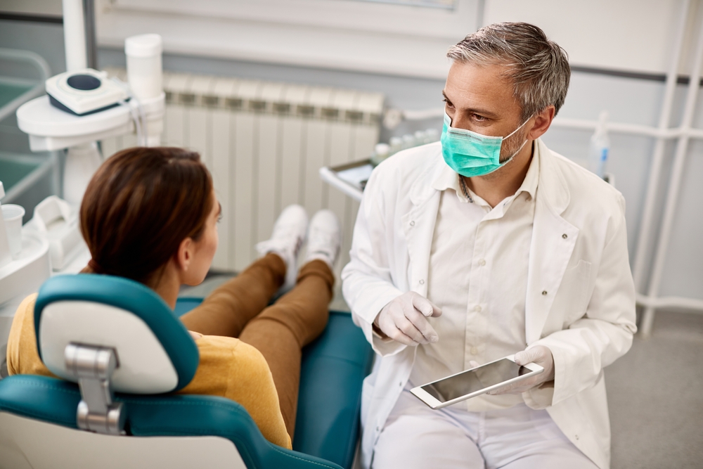 Orthodontist speaking to patient.