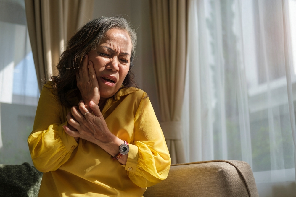 Older woman with tooth pain.